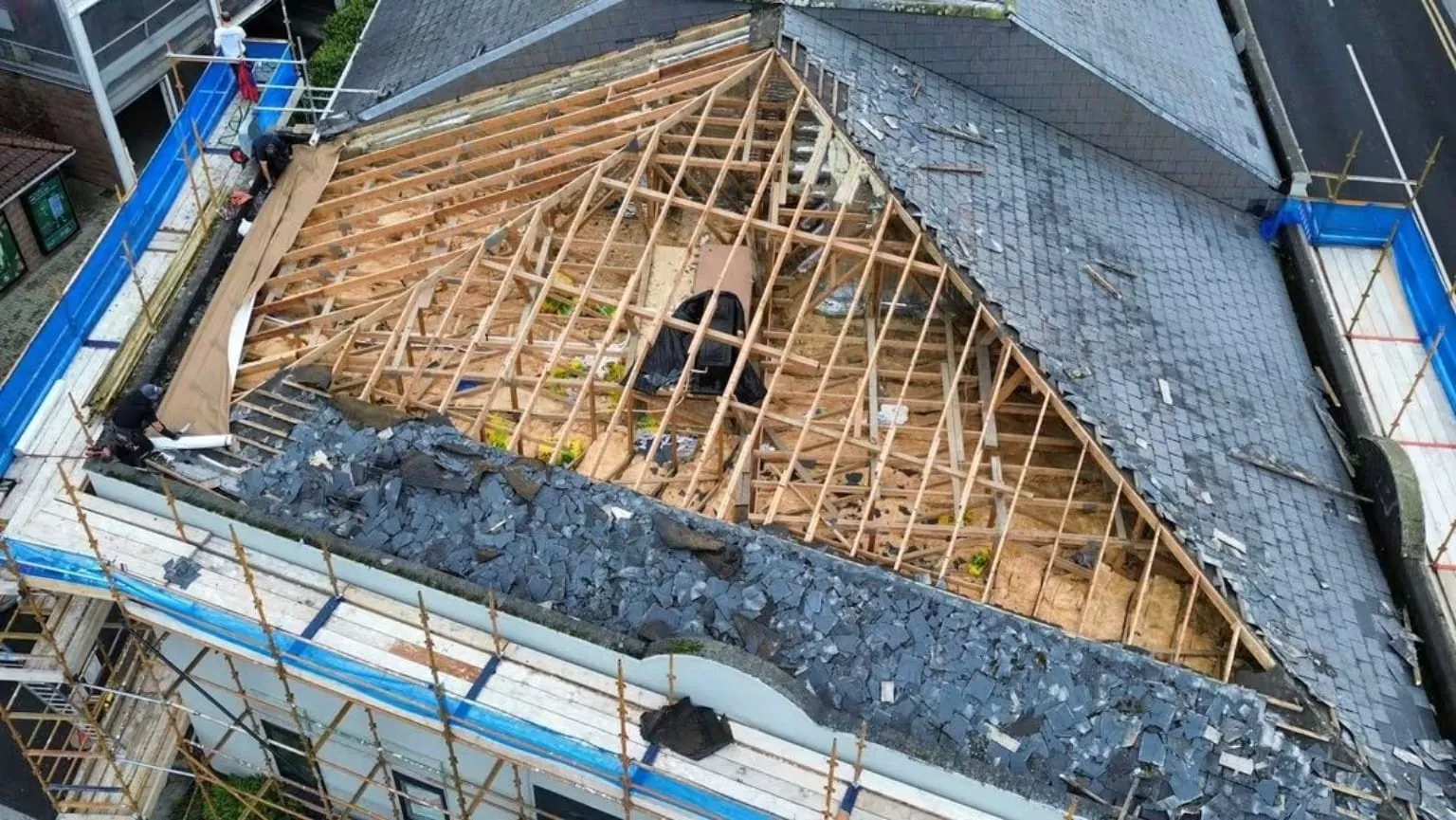 Old slates stripped to the roof timbers under scaffolding, County Meath