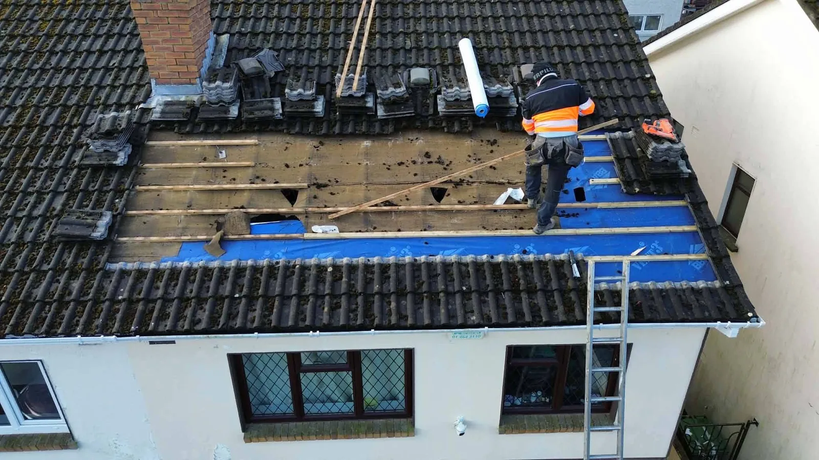 Section of a tiled roof stripped back for repair