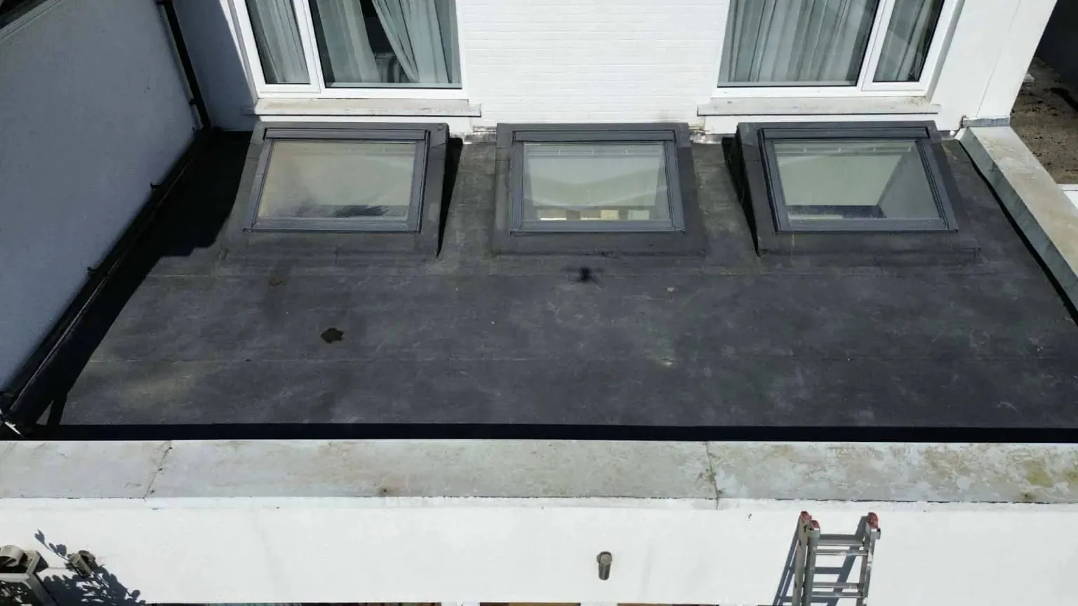 Torch-on felt flat roof with three rooflights