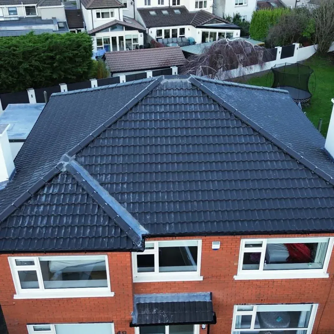 Tiled hipped roof on a red-brick semi
