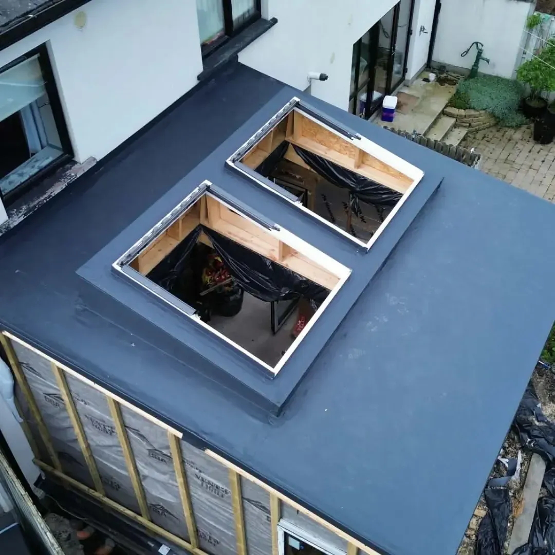 Flat roof with two rooflights being fitted
