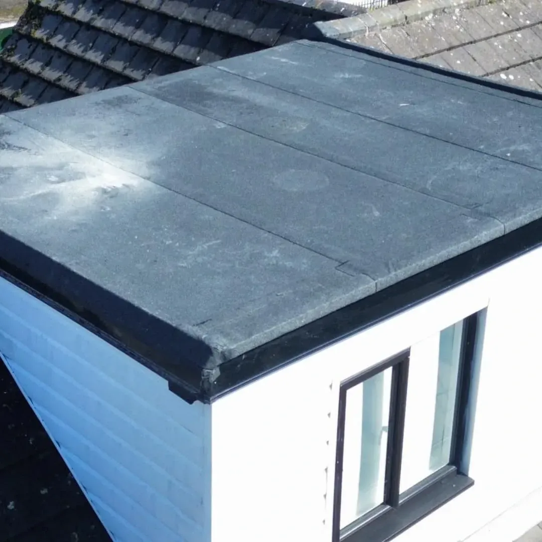 Flat roof edge trim on a rendered extension