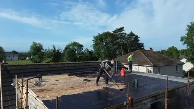 Roofers laying a large flat roof