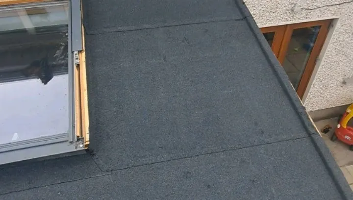 Felt flat roof meeting a wall